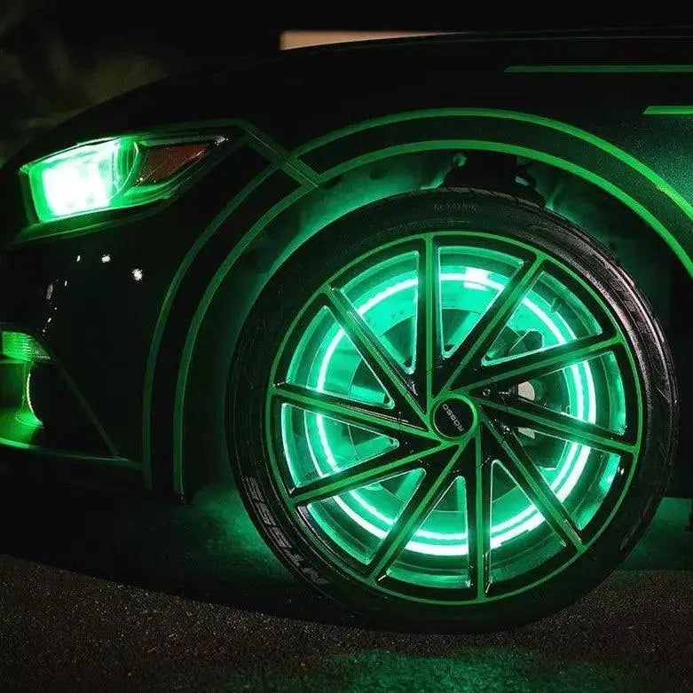 Close-up of a car wheel featuring Underglow green LED wheel glow lighting.
