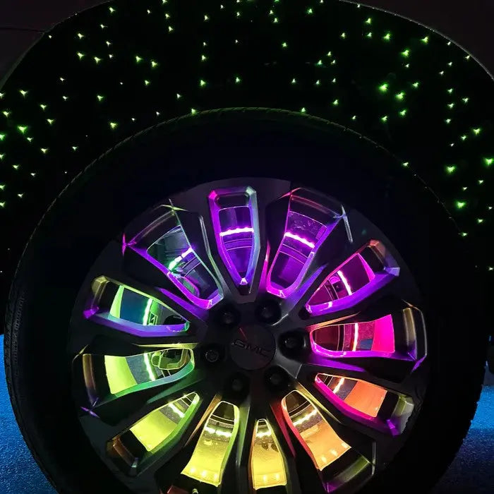 Underglow multi-color LED wheel glow lighting kit installed on a GMC vehicle rim