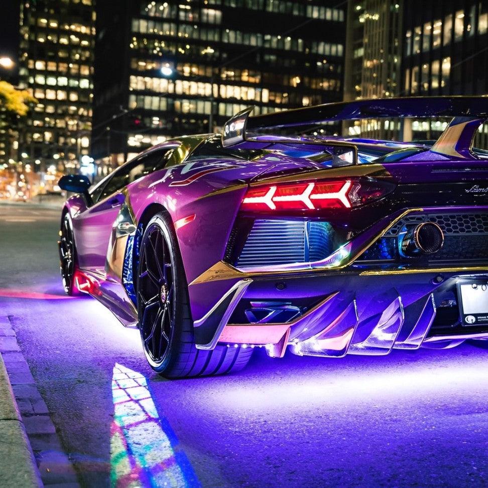 Lamborghini Aventador and purple LED underglow lights in a downtown setting.